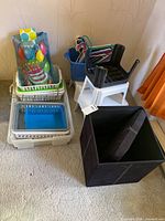 Group view showing storage bins, hangers in tote, stools, ottoman cube and gift bags