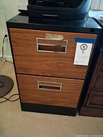 Front view showing two drawers with woodgrain fronts and handles