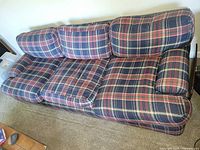 Top view of full sofa showing plaid upholstery and cushion configuration