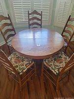 Overall view of round table with five matching chairs