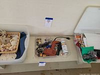 Three storage bins with seashells basket, tools, spray paint and gift bags