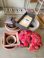 Group of stacked pots, planter box, lantern and faux poinsettia basket