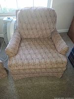 Front view of upholstered armchair showing overall style and pattern
