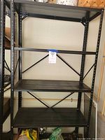 Front view of entire black steel 4-shelf rack