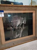 Front view of framed bobcat artwork in rustic wood frame