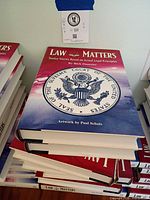 Front view of stacked copies showing cover title and artwork