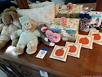 Overall view showing plush toys, pillow, coasters, gift boxes, ceramic orbs and scrunchies on dresser