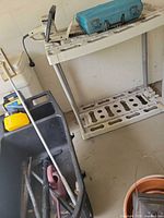 Overall view of workbench, Makita case and hedge trimmer