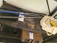 Four putters and canvas tote on shelf