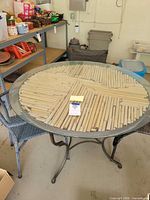 Full view of round patio table with chairs underneath