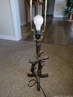 Branch-form resin lamp base with bulb and brass harp