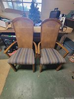 pair of armchairs showing cane backs, striped seats, wood frames