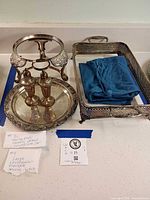 Group view showing round tray, rectangular tray, chafing stand, salt & pepper shakers, blue cloth