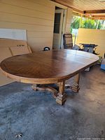 Full view of assembled oval dining table showing leaf inserted