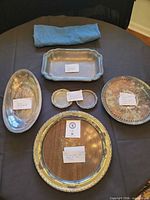 All items grouped: five trays, two coasters, cloth