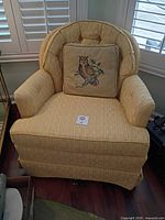 Front view of tufted armchair with owl pillow