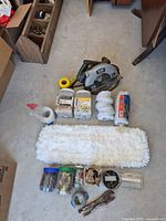 Overview of all tools, fasteners, mop pad and saw arranged on floor