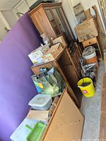Overall view of china cabinet, nightstand, boxes, buckets and accessories