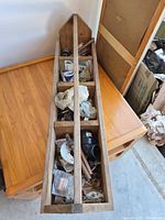 long wooden divider caddy filled with assorted small plumbing fittings