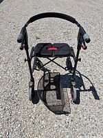 Front view of black Nexus rollator showing seat, backrest, basket and four wheels