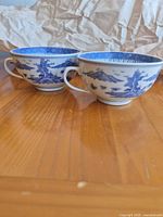 Two matching blue and white porcelain teacups exterior view