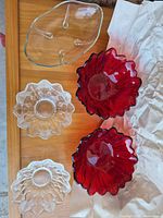 All five glass bowls including clear divided dish, two clear pressed bowls, two red bowls