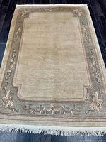 Full view of the rug, showing central field and complete border