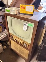 Front view of Admiral console TV with clock radio on top