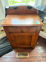 Front view of washstand showing backsplash, drawer, cabinet door and overall finish