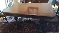 Full view of table showing top surface, leaf in place, double pedestal base