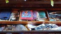 Drawer overview showing linens, glass napkin rings, paper napkins, figurine and other small items