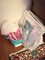 Quilt folded in fabric tote with clear storage bags nearby