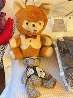 Plush fox and teddy on knit throw