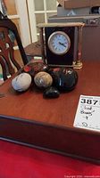 Clock and stones grouped on tabletop