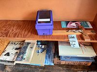 Books, crucifix, storage bin on shelf