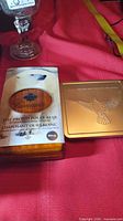 Outer packaging of both sets: wood-sleeved Polar Bear box and gold metal Millennium tin