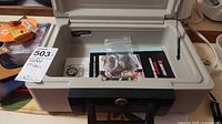 Open Sentry safe showing interior with paperwork and keys