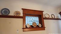Overall shelf view showing all eight decorative plates