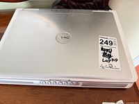 Top view of closed Dell Inspiron laptop showing Dell logo and lot sticker