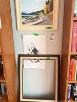Overall view showing painting above, wolf print taped below, spare frame leaning