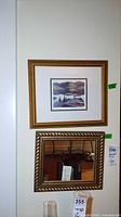 Print above mirror showing both framed pieces on wall