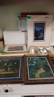 Group overview showing five framed/matted prints on surface