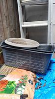 Crate, planter, soil bag, rake, tarp visible