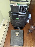GE radio on top of BREATHEasy air cleaner with bathroom scale on floor