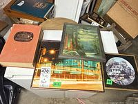 Group overview showing three framed prints and hardcover book