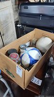 Cardboard box containing balls and jars