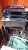 Sony CD changer on wood side table with lot tag visible