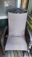 Front view of one chair showing mesh fabric and tear