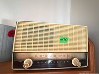 Front view of RCA Victor tabletop radio showing grill, knobs, dial and size label