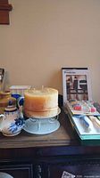 Full lot view showing knives, candle on stand, hen dish and teapot